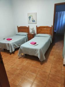 Postel nebo postele na pokoji v ubytování Apartamentos Nelly