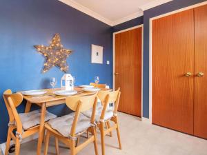 a dining room with a table and a star on the wall at Strathy in Dornoch