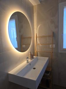 a bathroom with a white sink and a mirror at Casa Isabel Charm Apartment in San Benedetto del Tronto +19 photos
