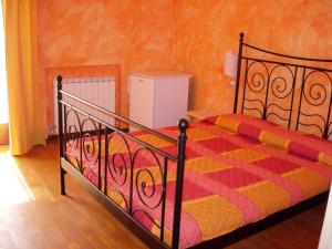 a bedroom with a bed with a colorful comforter at Varavventura in Riccò del Golfo di Spezia