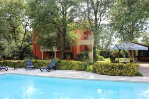 a swimming pool with two chairs and a building at Villa Plavo More in Novigrad Istria