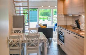 a kitchen and living room with a table and chairs at Two-Bedroom Holiday Home In Bruinisse in Bruinisse