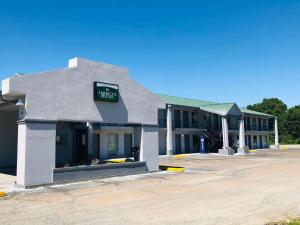 a building with a sign on the side of it at America's Best Inn - Brinkley in Brinkley