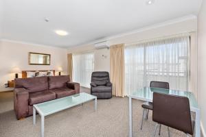 a living room with a couch and a glass table at Comfort Inn Centrepoint Motel in Lismore