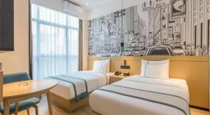 Łóżko lub łóżka w pokoju w obiekcie City Comfort Inn Wuhan Huangpu