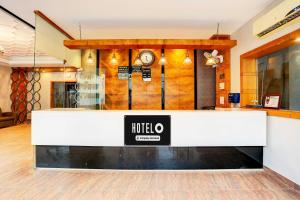 a hotel lobby with a reception desk and a clock at Townhouse Alwar Bus Station in Alwar