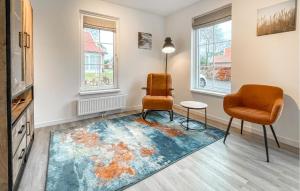 a living room with two chairs and a rug at Gorgeous Home In Hoge Hexel With Sauna in Hoge-Hexel +29 photos