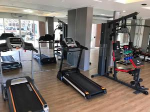 a gym with several treadmills and exercise bikes at The Residence Prachinburi in Si Maha Phot