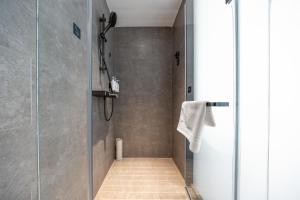a shower stall with a glass door in a bathroom at Atour Hotel Jinan Laiwu 