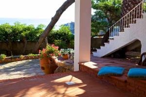 a house with a patio with stairs and flowers at Villa Angela in Santa Teresa Gallura