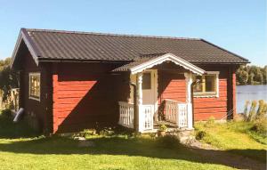 a small house with a porch on a lawn at Stunning Home In Borlänge With Wifi in Borlänge