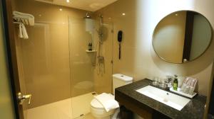 a bathroom with a shower and a sink and a toilet at The Quarter Saladaeng by UHG in Bangkok