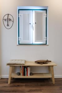 a mirror on a wall next to a wooden bench at Studio Galé Terceiro in Lisbon