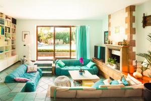 a living room with blue couches and a fireplace at Villa Cannizzaro in Catania