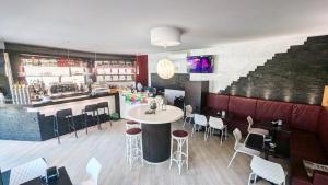 a restaurant with a table and chairs and a bar at Pie Castello in Susegana