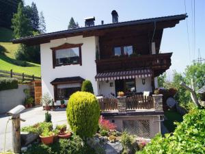 a small house with a balcony in a garden at Holiday apartment near ski area in Aschau