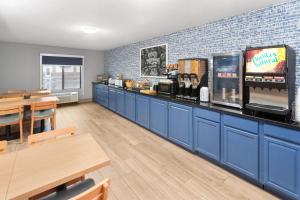 a fast food restaurant with blue cabinets and a counter at AmericInn by Wyndham Reedsburg in Reedsburg