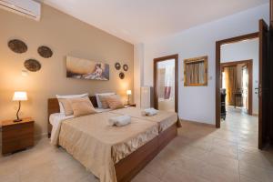 a bedroom with a large bed with two towels on it at Butterfly Villa in Theologos