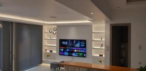 a living room with a flat screen tv on the wall at Helios Boutique Maisonette in Astypalaia