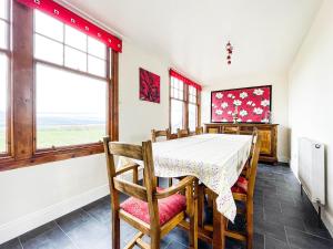 a dining room with a table and chairs at Fourpenny Cottage - Uk34744 in Embo