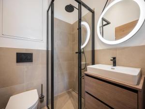 a bathroom with a sink and a mirror at Apartment in Kirchberg near Ski Lift in Kirchberg in Tirol