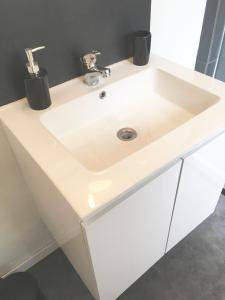 a white sink in a bathroom with a mirror at Home sweet Home by Victoria in Aix-les-Bains