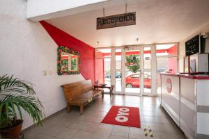 a restaurant with a bench and a red rug at OYO La Casita in Quinceo