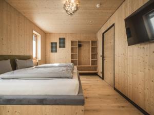a bedroom with a bed and a flat screen tv at Chalet in Bichlbach near Ski Slopes in Bichlbach