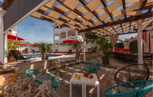 a patio with chairs and a table and a pool at Nice Home In Turanj With Jacuzzi in Turanj +49 photos