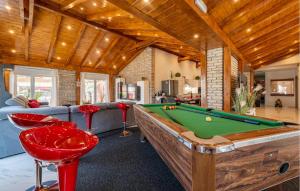 a living room with a pool table and some chairs at Nice Home In Turanj With Jacuzzi in Turanj