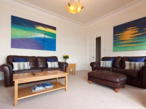 a living room with two couches and a coffee table at Oystercatcher in Kingswear