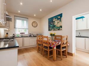 a kitchen and dining room with a table and chairs at Oystercatcher in Kingswear