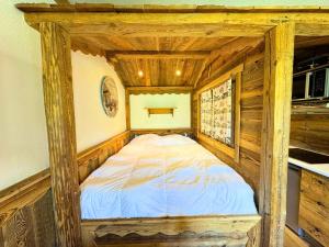 a bed in the corner of a room at Résidence Necou - Studio déco style chalet en bord de pistes MAE-5954 in Les Menuires