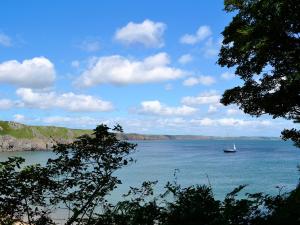 a boat in the middle of a large body of water at Pebble Cottage - Hw7447 in Broad Haven
