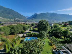 an aerial view of a garden with mountains in the background at MARY HOUSE @ in Sondrio