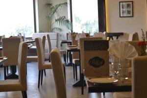 a dining room with tables and chairs with a box at The Legend in Allahābād +21 photos