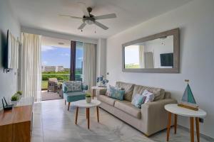 a living room with a couch and a mirror at Luxury Stay with Beach, Golf, Pool, Casino and Spa in Punta Cana