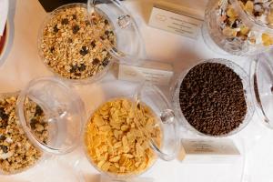 a display of different types of cereals in glass containers at Villa Nicolli Romantic Spa Resort - Adults Only in Riva del Garda
