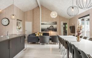 a kitchen and dining room with a table and chairs at Nice Home In Vejby With Sauna in Vejby