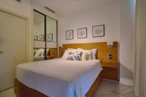 a bedroom with a large bed and a mirror at Luxury Stay with Beach, Golf, Pool, Casino and Spa in Punta Cana +79 photos