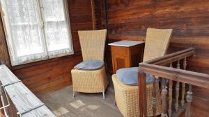 a porch with two chairs and a table and a desk at Chalet Spillstatt in Grindelwald