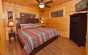 a bedroom with a bed and a ceiling fan at Bearfoot Lodge in Gatlinburg