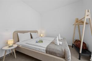 Postel nebo postele na pokoji v ubytování Apartmani Paliska