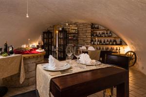 a dining room with a table with wine glasses at Villa Nicolli Romantic Spa Resort - Adults Only in Riva del Garda
