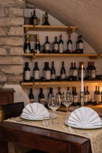 a table with glasses and napkins and wine bottles at Villa Nicolli Romantic Spa Resort - Adults Only in Riva del Garda