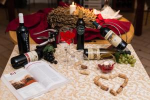 a table topped with bottles of wine and wine glasses at Villa Nicolli Romantic Spa Resort - Adults Only in Riva del Garda