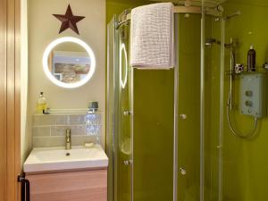 a bathroom with a shower and a sink and a mirror at The Outside Room in Ladybank