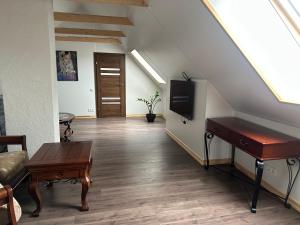 a living room with a piano and a flat screen tv at D&R Apartments in Mažeikiai