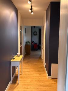 a hallway with a table in a room at Apartament szafirowy z basenem koło Łeby in Żarnowska +8 photos