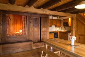 a kitchen with wooden cabinets and a wooden table at Gîte Gîtes de France 9/11 personnes à Brion in Brion